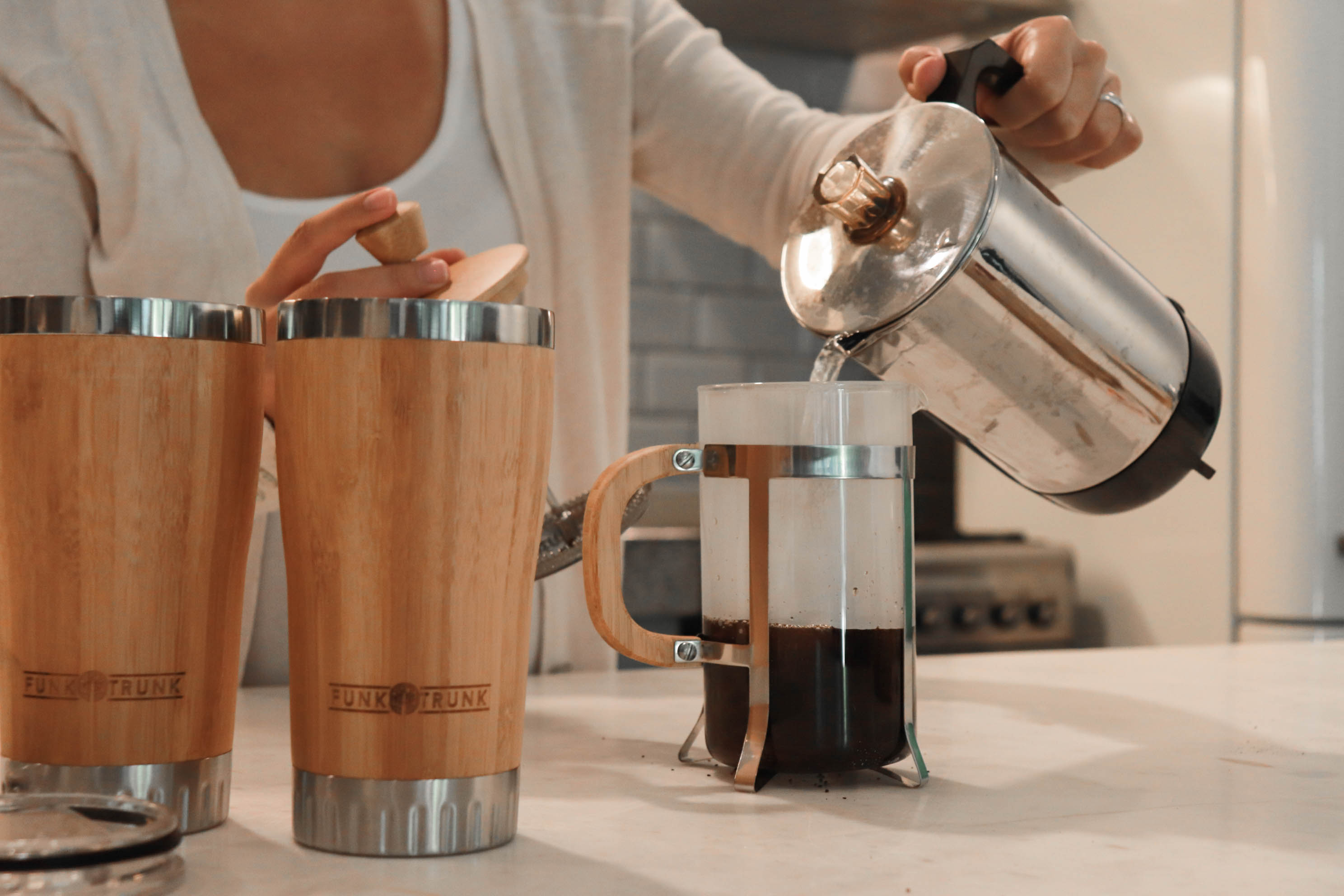 Pouring hot water to your Funk Trunk Bamboo French Press to start your day